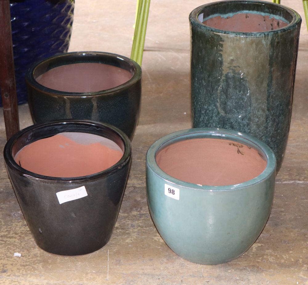 Four assorted glazed garden urns, largest 38cm high